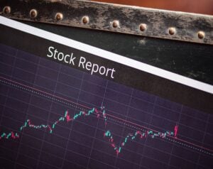 Stock Report screen with a candlestick chart showing fluctuating prices on a dark grid.