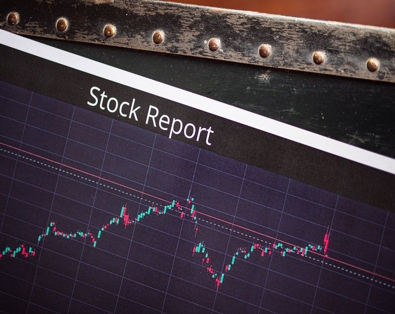 Stock Report screen with a candlestick chart showing fluctuating prices on a dark grid.